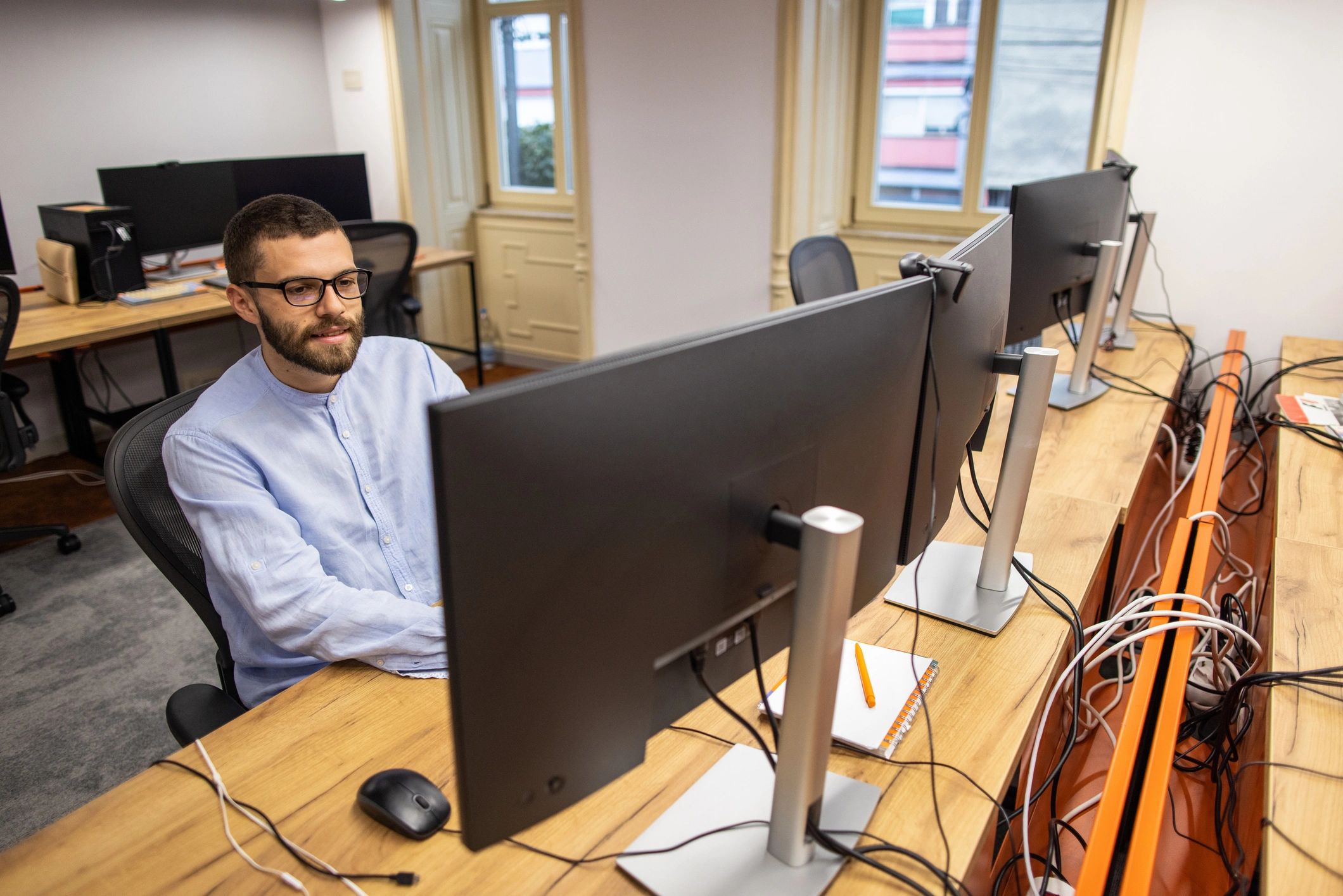 Technician working at a desktop computer in an office