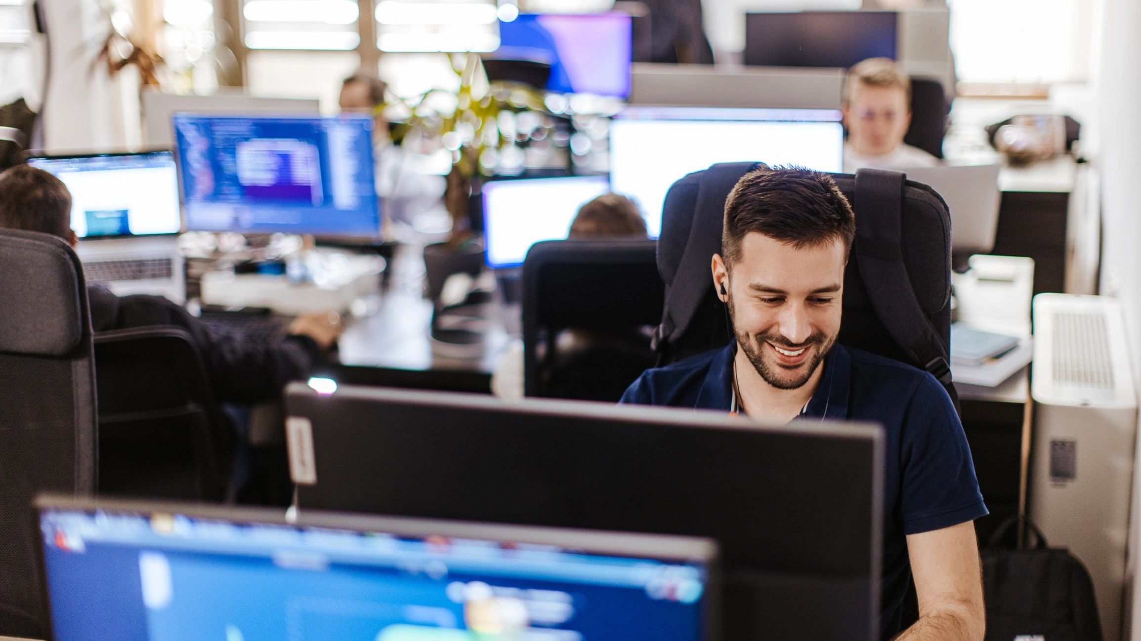 IT professional working at a computer in a modern office