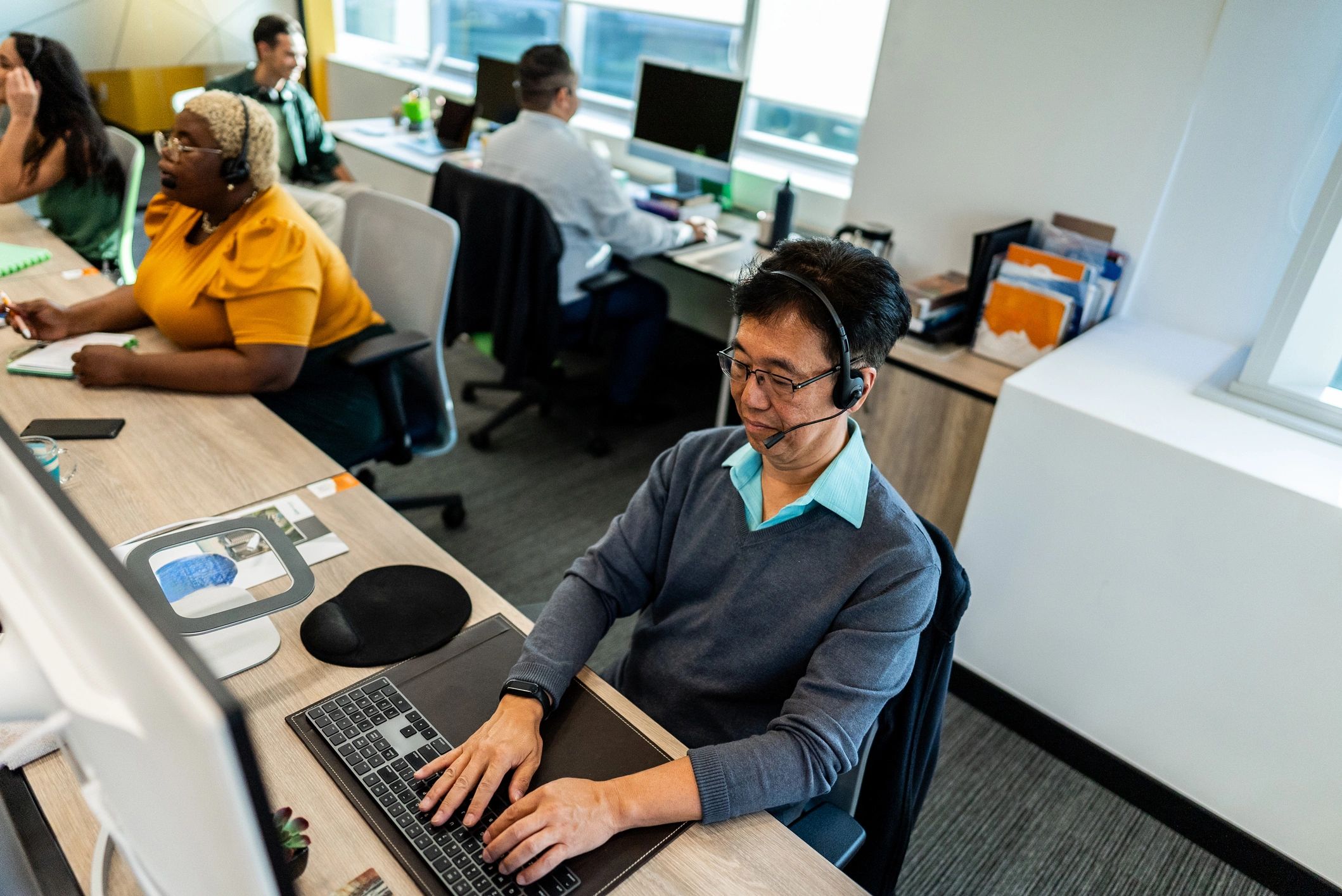 Support professional working at a computer in an office